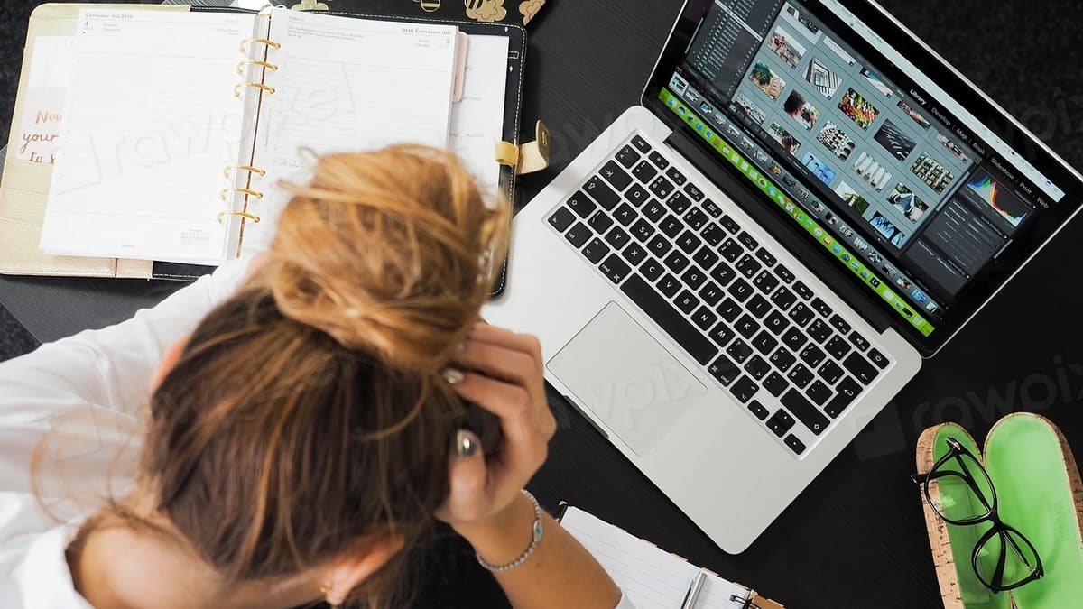 Stressed businesswoman working at a cluttered desk, illustrating common validation mistakes founders make