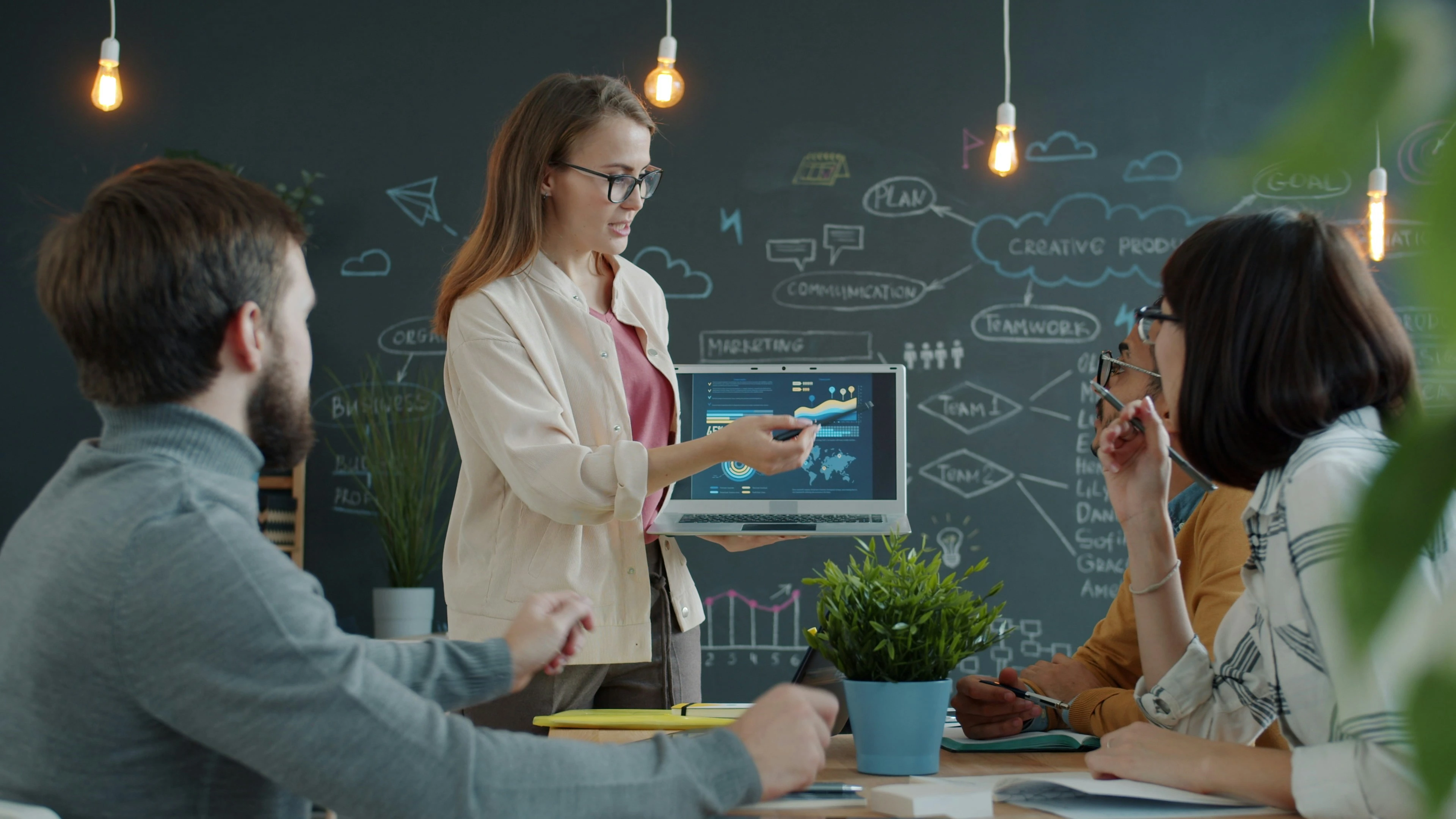 Founder presenting a startup pitch deck to a small team of investors in a collaborative setting